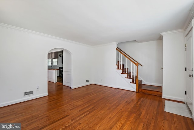 unfurnished living room featuring wood-type flooring and ornamental molding