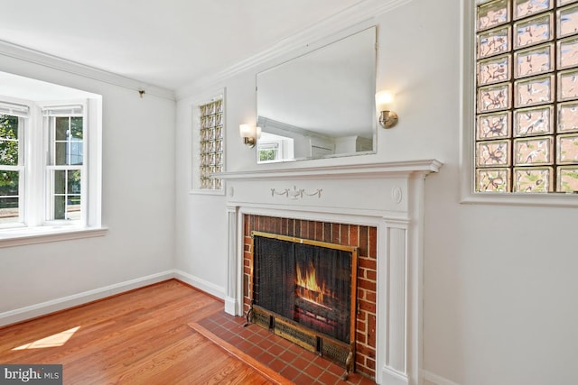 unfurnished living room featuring ornamental molding, a fireplace, and hardwood / wood-style floors