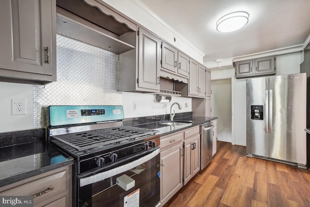 kitchen with sink, appliances with stainless steel finishes, gray cabinetry, ornamental molding, and custom range hood