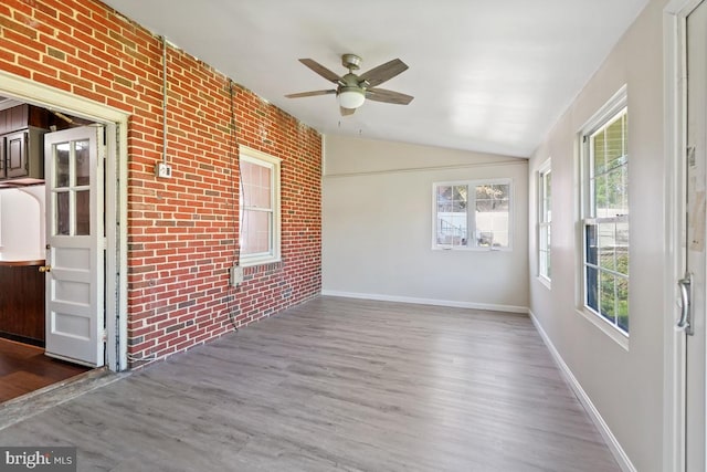 unfurnished sunroom featuring vaulted ceiling and ceiling fan