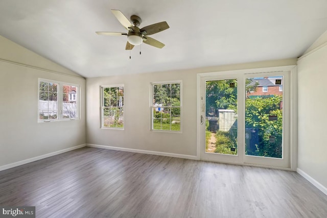 unfurnished sunroom with ceiling fan, lofted ceiling, and plenty of natural light