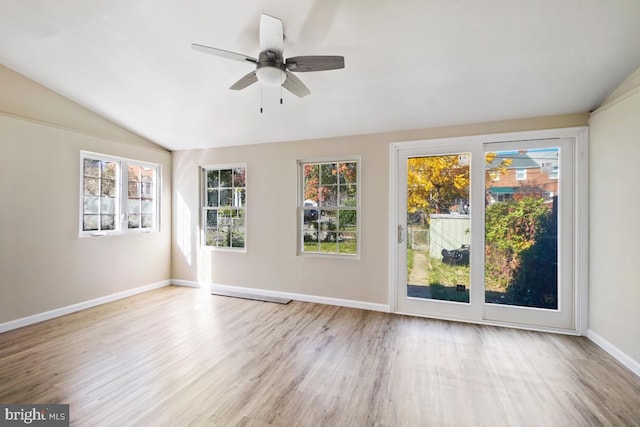 interior space with ceiling fan, a healthy amount of sunlight, and vaulted ceiling