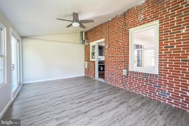 unfurnished sunroom featuring lofted ceiling and ceiling fan