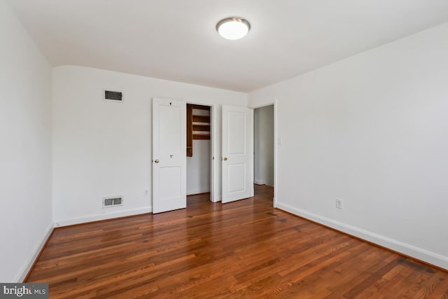 unfurnished bedroom featuring dark hardwood / wood-style floors