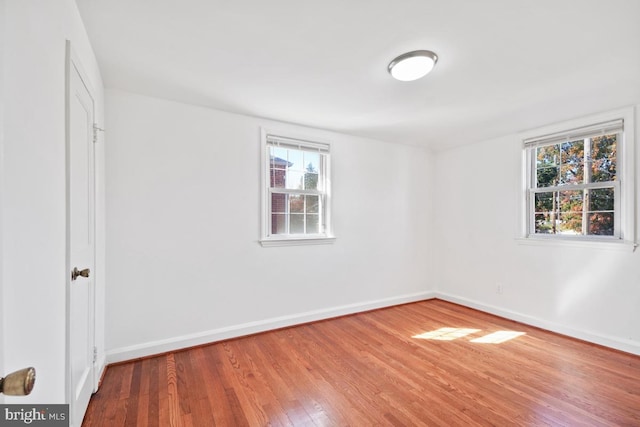 unfurnished room featuring hardwood / wood-style flooring