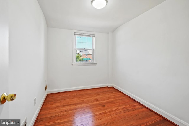 spare room with wood-type flooring