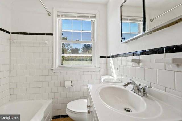 full bathroom featuring shower / bathtub combination, vanity, toilet, and tile walls