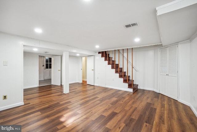 basement featuring dark hardwood / wood-style flooring