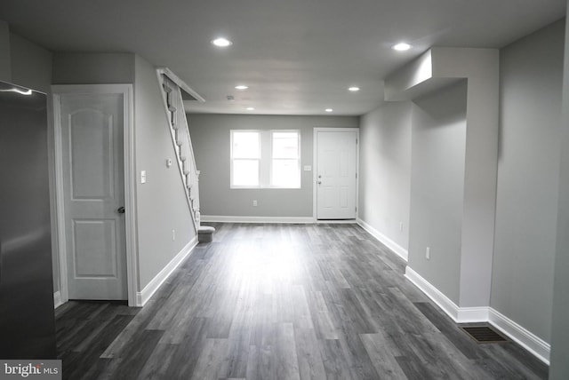 empty room with dark hardwood / wood-style flooring