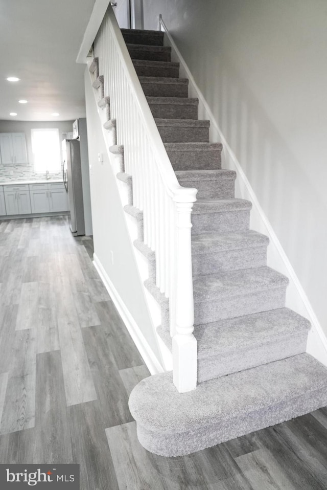 stairs featuring wood-type flooring