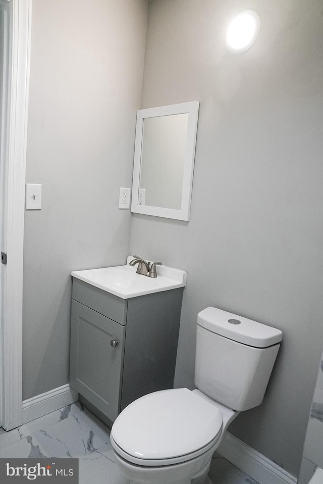 bathroom featuring vanity, tile patterned flooring, and toilet