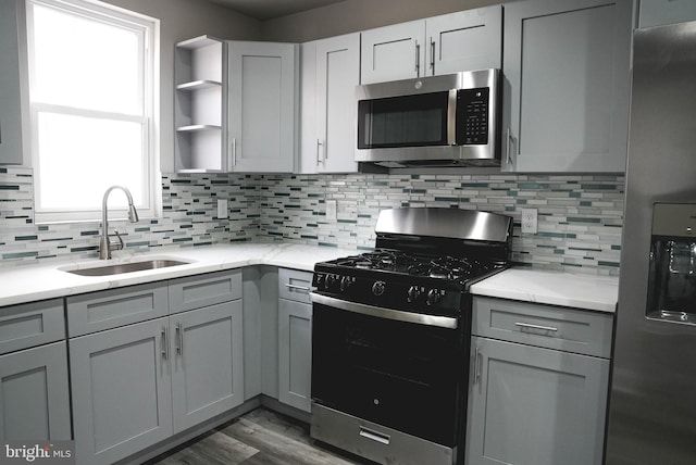 kitchen with plenty of natural light, sink, stainless steel appliances, and backsplash