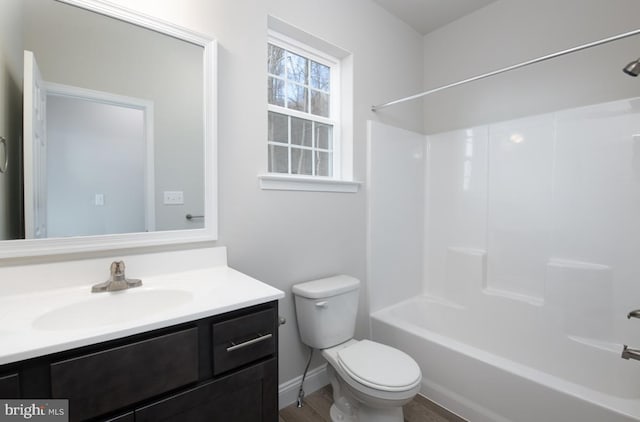 full bathroom with vanity, wood-type flooring, bathing tub / shower combination, and toilet