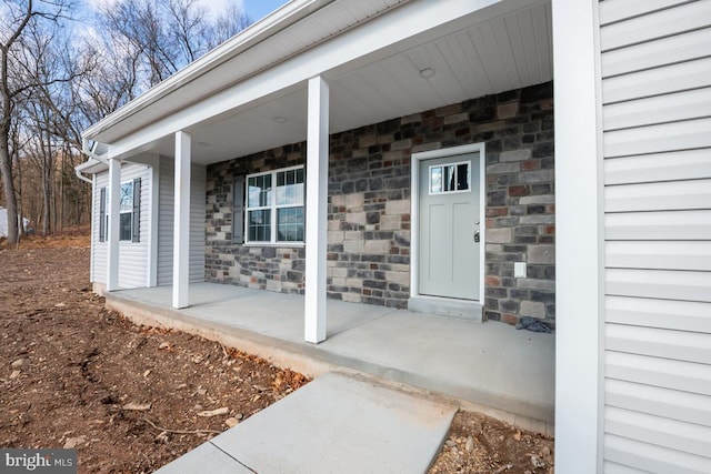 doorway to property featuring covered porch