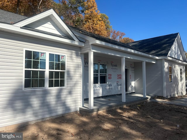 rear view of house with covered porch