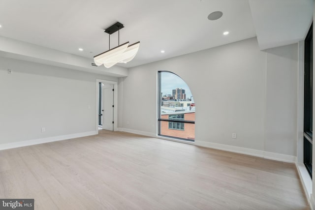 unfurnished room with light hardwood / wood-style floors