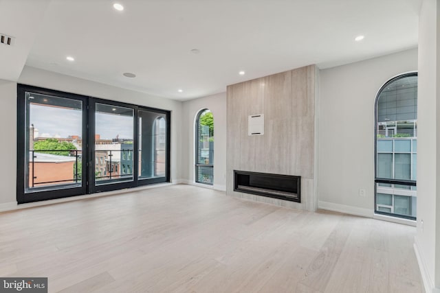 unfurnished living room with light hardwood / wood-style flooring and a fireplace