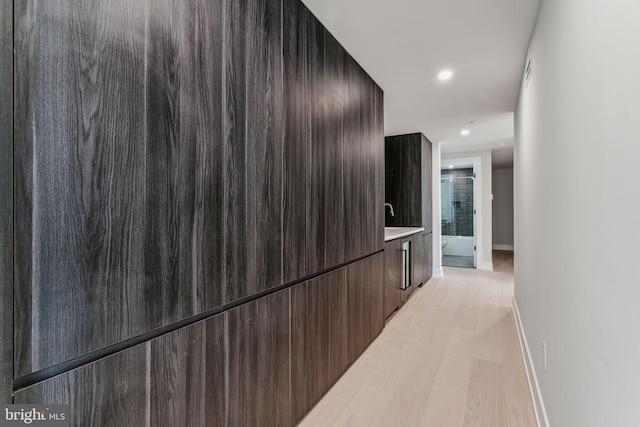 hallway with light hardwood / wood-style flooring