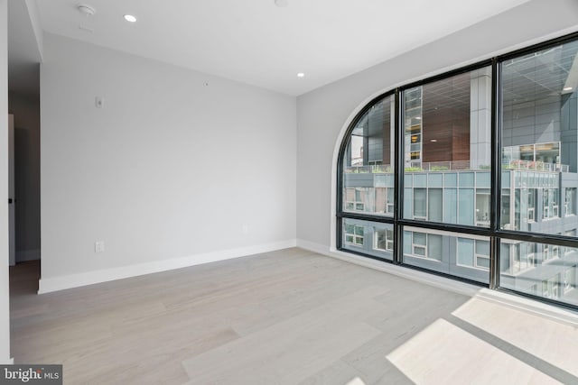 unfurnished room with light wood-type flooring