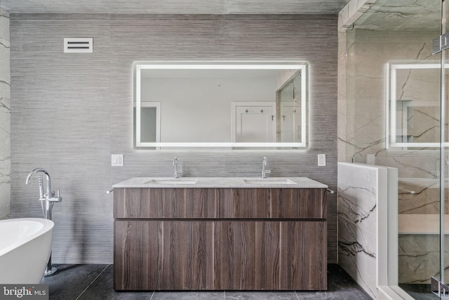 bathroom with vanity, a bathing tub, and tile walls