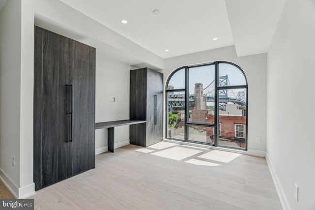 empty room with light hardwood / wood-style floors