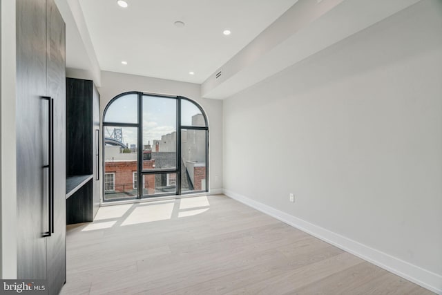 spare room with light hardwood / wood-style floors