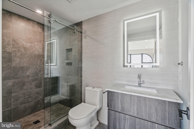 bathroom with walk in shower, vanity, toilet, and tile walls