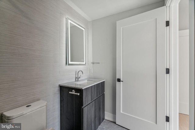 bathroom with vanity, tile patterned flooring, toilet, and tile walls