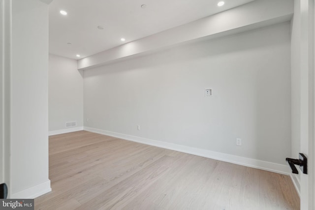 basement with light hardwood / wood-style flooring