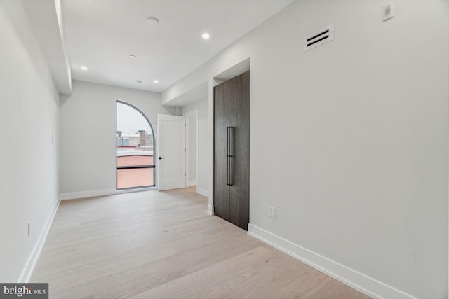 empty room with light hardwood / wood-style flooring