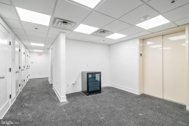 interior space with a drop ceiling and elevator