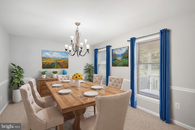 dining space with light carpet and a notable chandelier