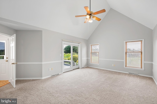 empty room with ceiling fan, high vaulted ceiling, and carpet