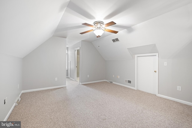 bonus room with vaulted ceiling, light carpet, and ceiling fan