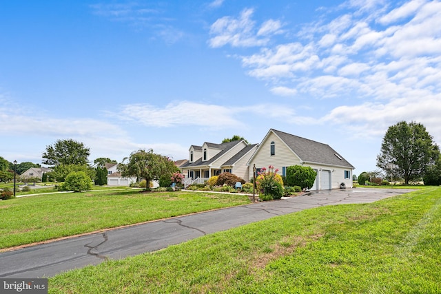 view of front of house featuring a garage and a front lawn