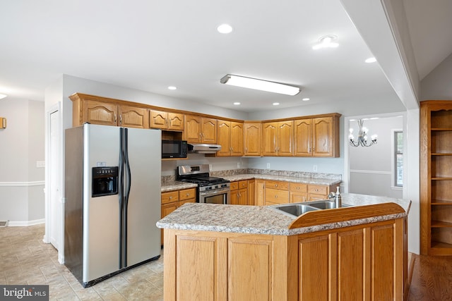 kitchen featuring stainless steel appliances, a kitchen island with sink, and sink