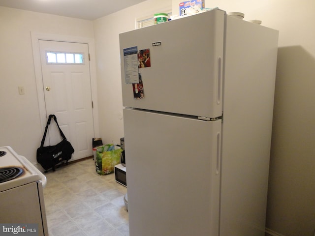 kitchen with white appliances and light tile patterned floors