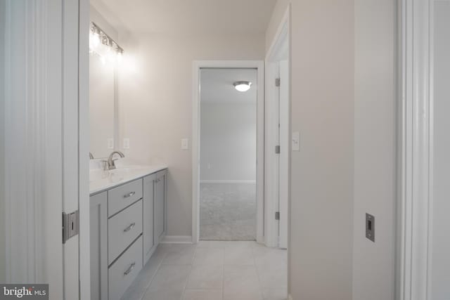 bathroom featuring tile patterned flooring, baseboards, and vanity