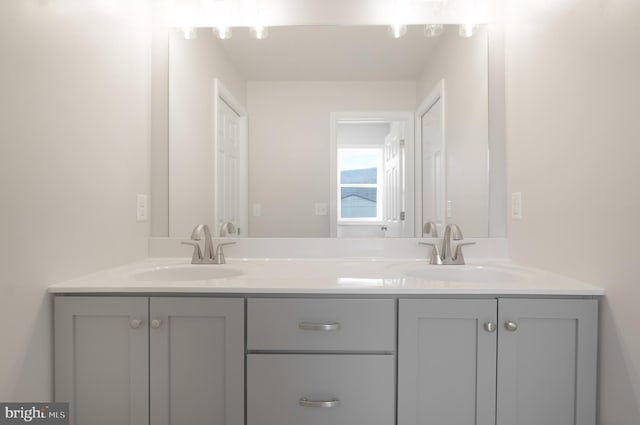 full bath with double vanity and a sink