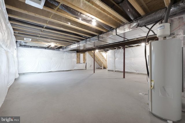 unfinished basement featuring water heater