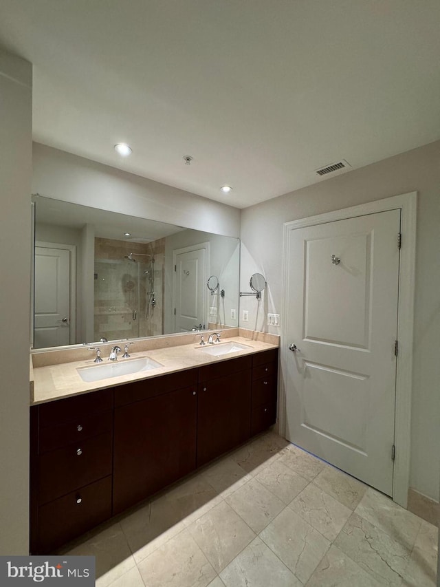 bathroom featuring vanity and a shower with shower door