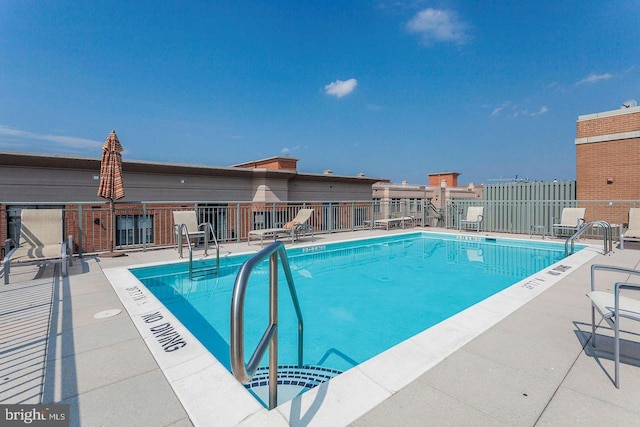 view of swimming pool with a patio