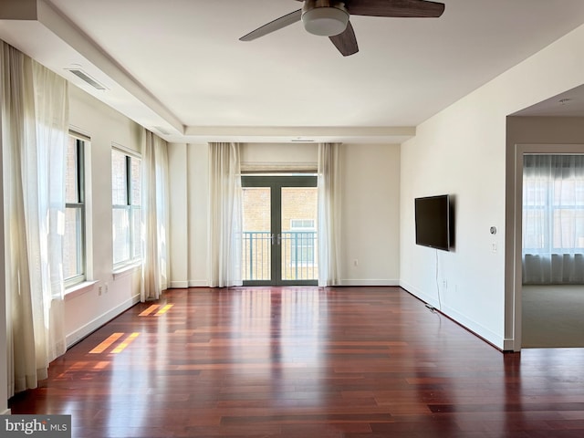 unfurnished room with french doors, ceiling fan, plenty of natural light, and dark hardwood / wood-style floors