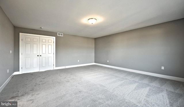 unfurnished bedroom featuring carpet and a closet