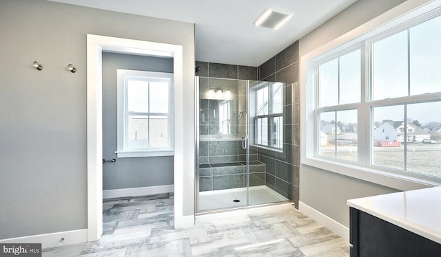 bathroom featuring a shower with door