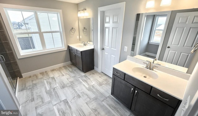 bathroom with a shower with door, vanity, wood-type flooring, and a healthy amount of sunlight