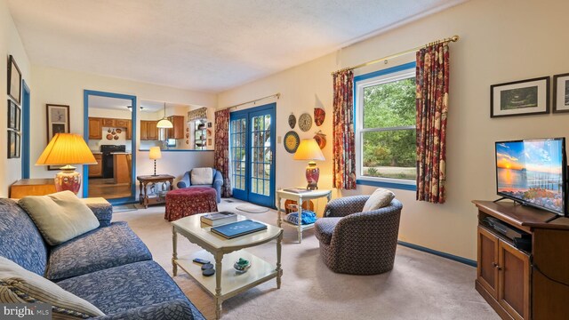 living room with light carpet and french doors