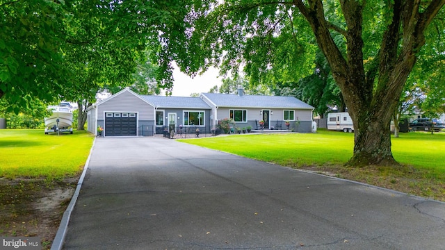 ranch-style home featuring a front yard and a garage