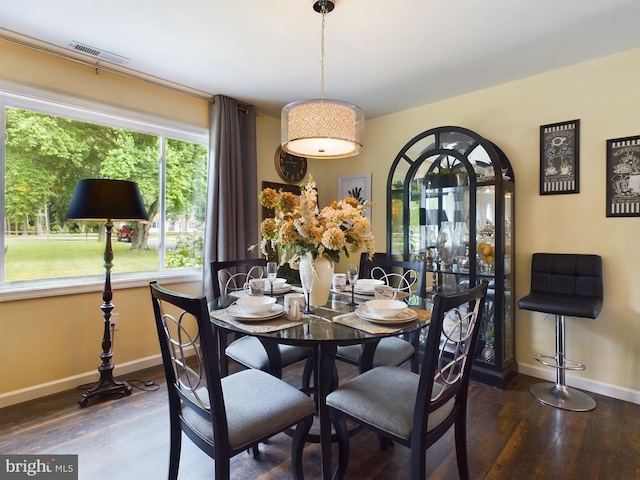 dining space featuring dark wood-type flooring