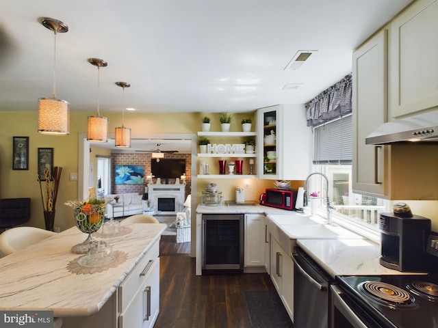 kitchen featuring dishwasher, white cabinetry, pendant lighting, beverage cooler, and dark hardwood / wood-style floors